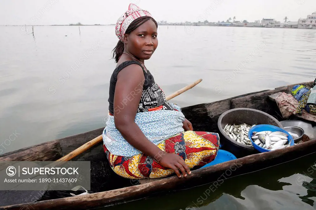 Fish seller on boat, Ayimlonfide-Ladji, Cotonou, Benin, West Africa, Africa