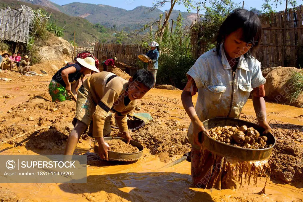 Boys searching for ruby stones in Mogok mining sites, Myanmar (Burma), Asia