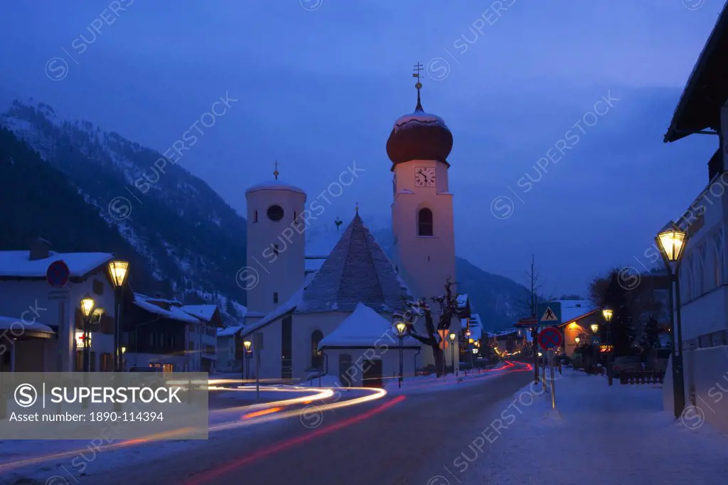 Church in winter snow at dusk, St. Anton am Arlberg, Austrian Alps, Austria, Europe
