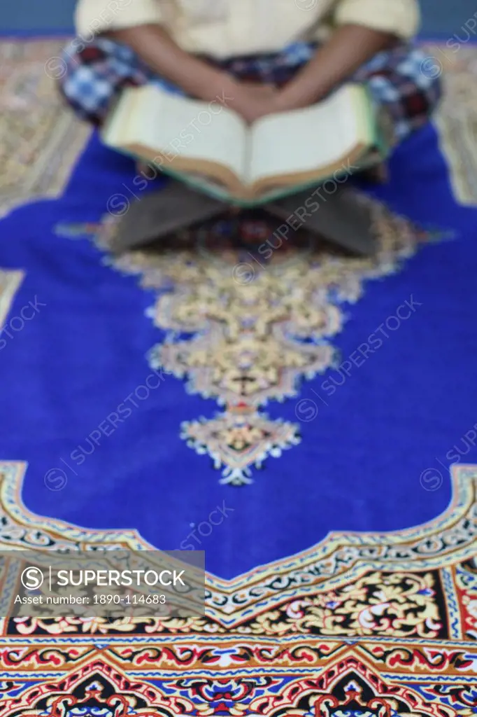 Muslim man reading the Quran in a mosque, Ho Chi Minh City, Vietnam, Indochina, Southeast Asia, Asia