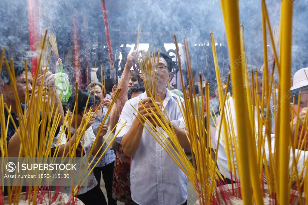Burning incense during Tet, the Vietnamese lunar New Year celebration, Thien Hau Temple, Ho Chi Minh City, Vietnam, Indochina, Southeast Asia, Asia
