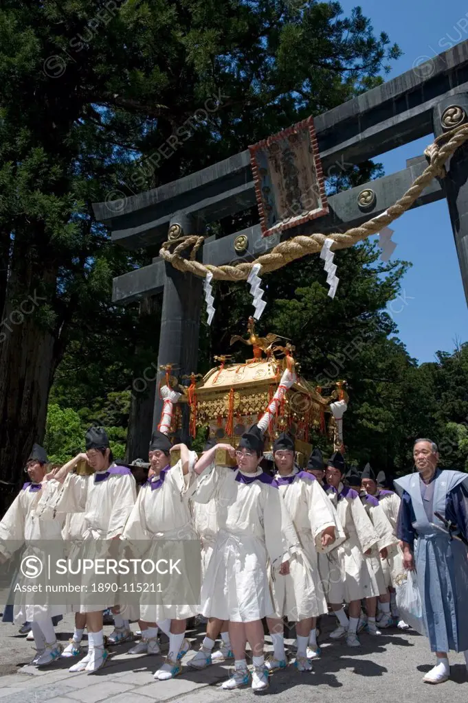 Mikoshi procession under torii gate at Futarasan Shrine during the Shunki Reitaisai festival in Nikko, Tochigi, Japan, Asia