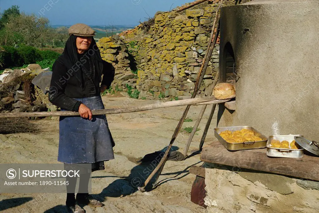 Woman baking bread, Alentejo, Portugal, Europe
