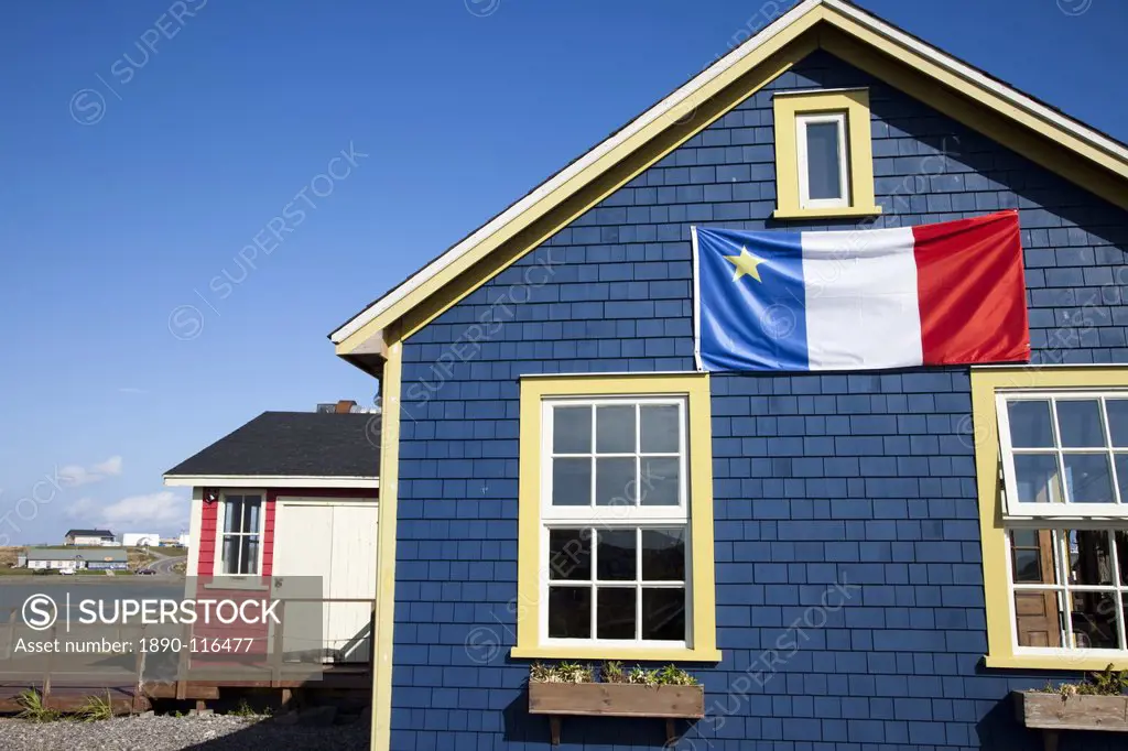 Acadian flag on blue house in La Grave, Ile Havre_Aubert, one of the Iles de la Madeleine Magdalen Islands, Gulf of St. Lawrence, Quebec, Canada, Nort...
