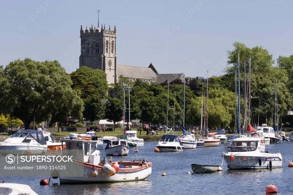 Christchurch Priory and pleasure boats on the River Stour, Dorset, England, United Kingdom, Europe