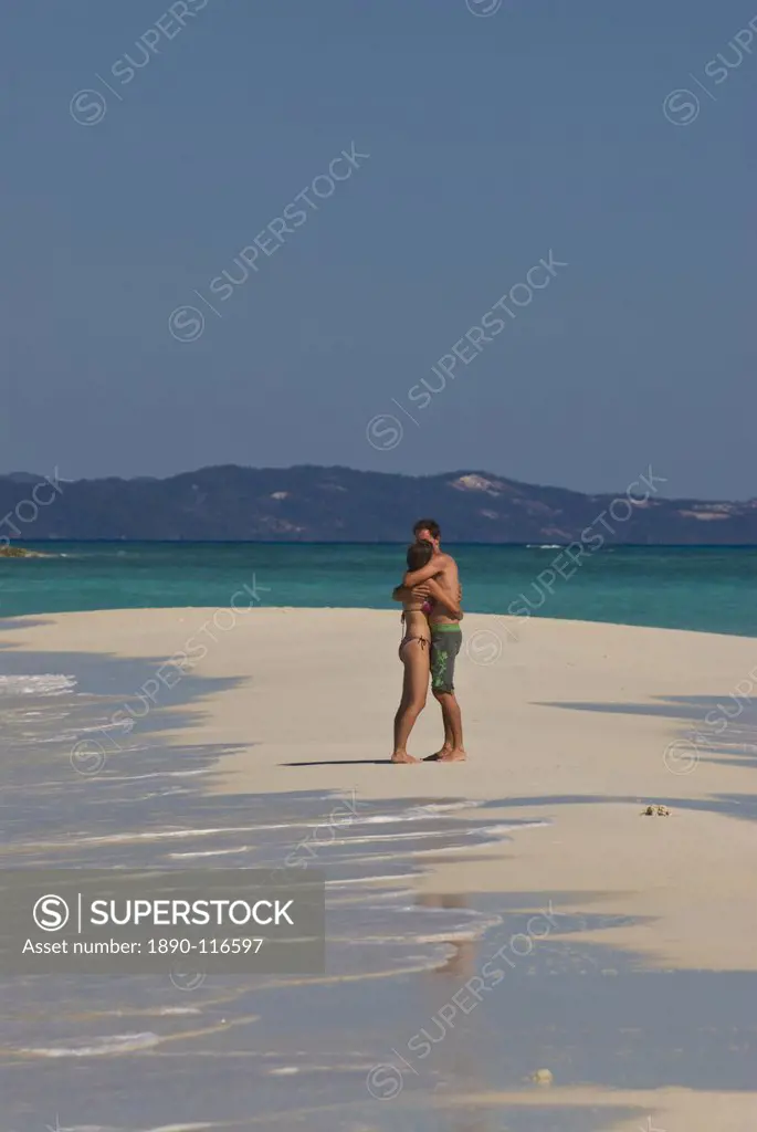 Happy couple on their honeymoon at the beautiful beach of Nosy Iranja near Nosy Be, Madagascar, Indian Ocean, Africa