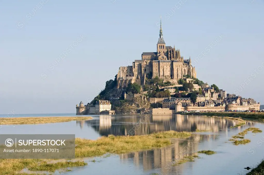 The island of Mont_Tombe and the 12th century Benedictine Abbey of Mont_St._Michel, UNESCO World Heritage Site, on the estuary of the river Couesnon, ...