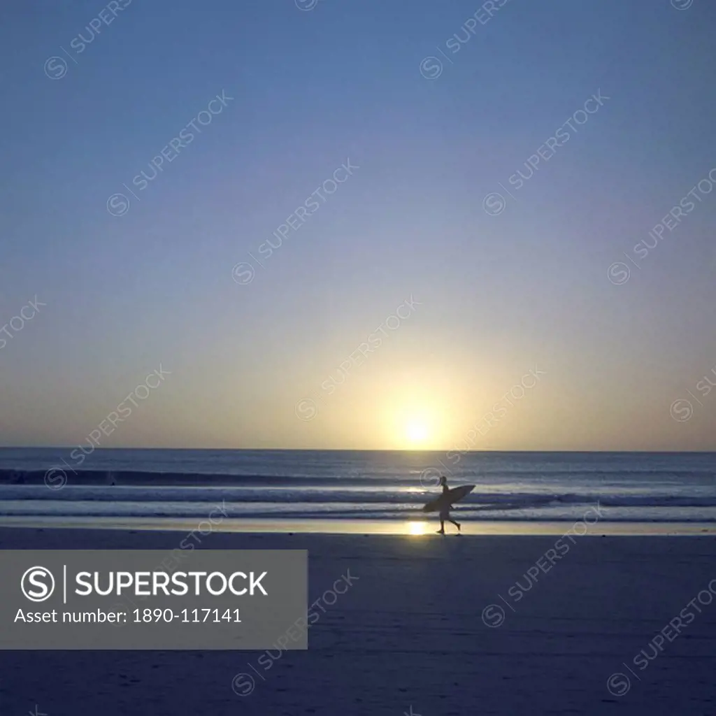 Silhouette of surfer walking on Avellanas Beach, Nicoya Peninsula, Costa Rica, Central America