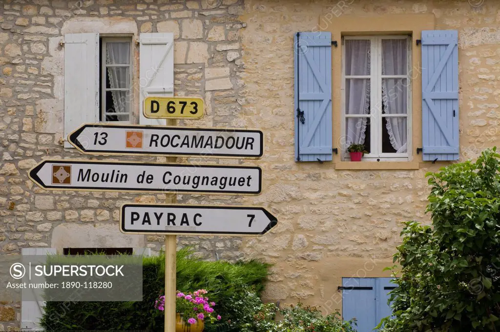 Road signs in front of an old house in the Dordogne region of France, Europe