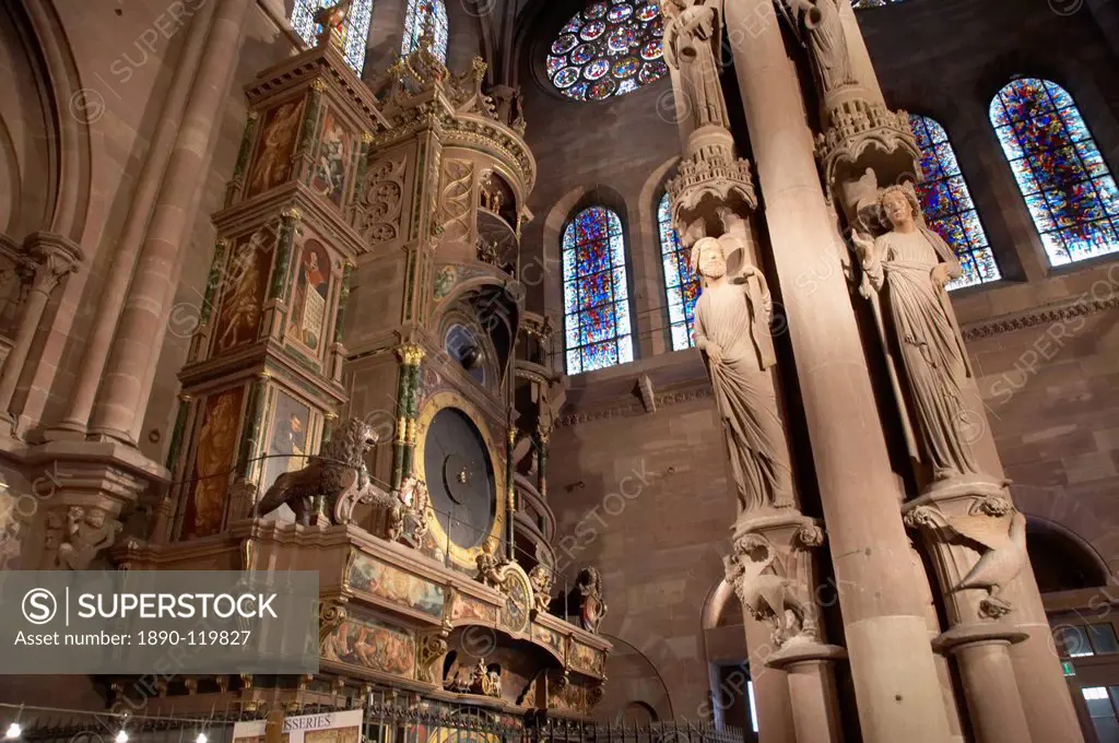 Pillar of Angels dating from the 13 century, and 16th century astronomical clock in the south transept of Notre_Dame gothic cathedral built of red san...