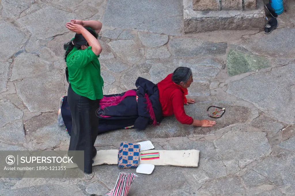 Pilgrims praying before the Jokhang Temple in Lhasa, Tibet, China, Asia