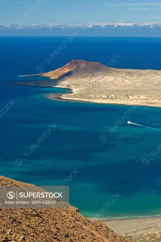 Volcanic cinder cone on Graciosa Island and the Graciosa to Lanzarote ferry in the Rio strait, seen from the Mirador del Rio on the north west coast o...