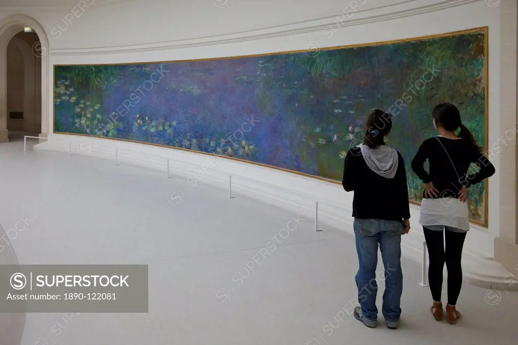 Two young women admire the Water_lilies by Claude Monet, Musee de L´Orangerie Museum, Paris, France, Europe