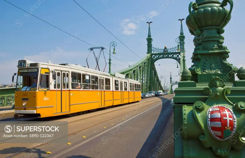 Yellow tram on The Liberty Bridge Szabadsag hid, over the Rver Danube, Vamhaz Korut street, Budapest, Hungary, Europe