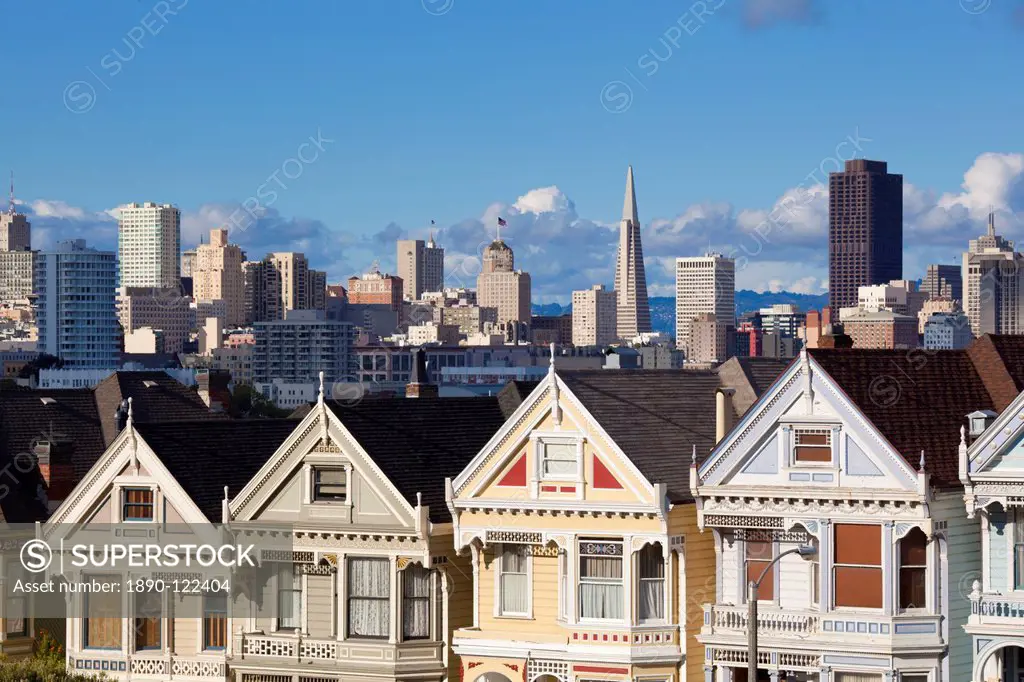 The famous Painted Ladies, well maintained old Victorian houses on Alamo Square, with the skyscrapers of the Financial district beyond, San Francisco,...