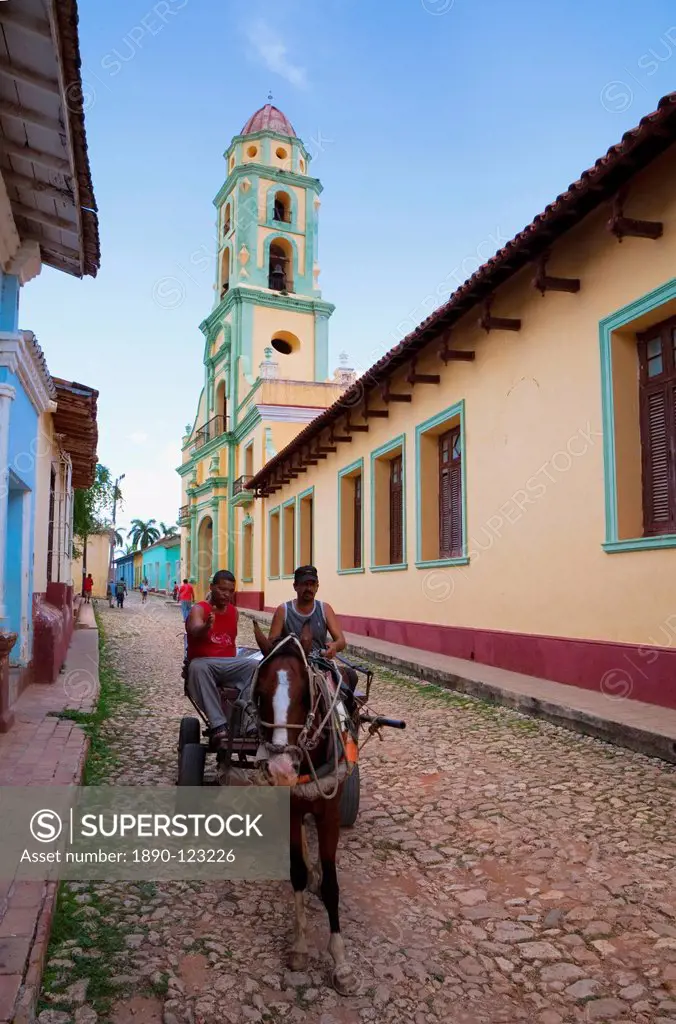 Two men on horse_drawn cart travelling along a quiet street in Trinidad, Sancti Spiritus Province, Cuba, West Indies, Caribbean, Central America