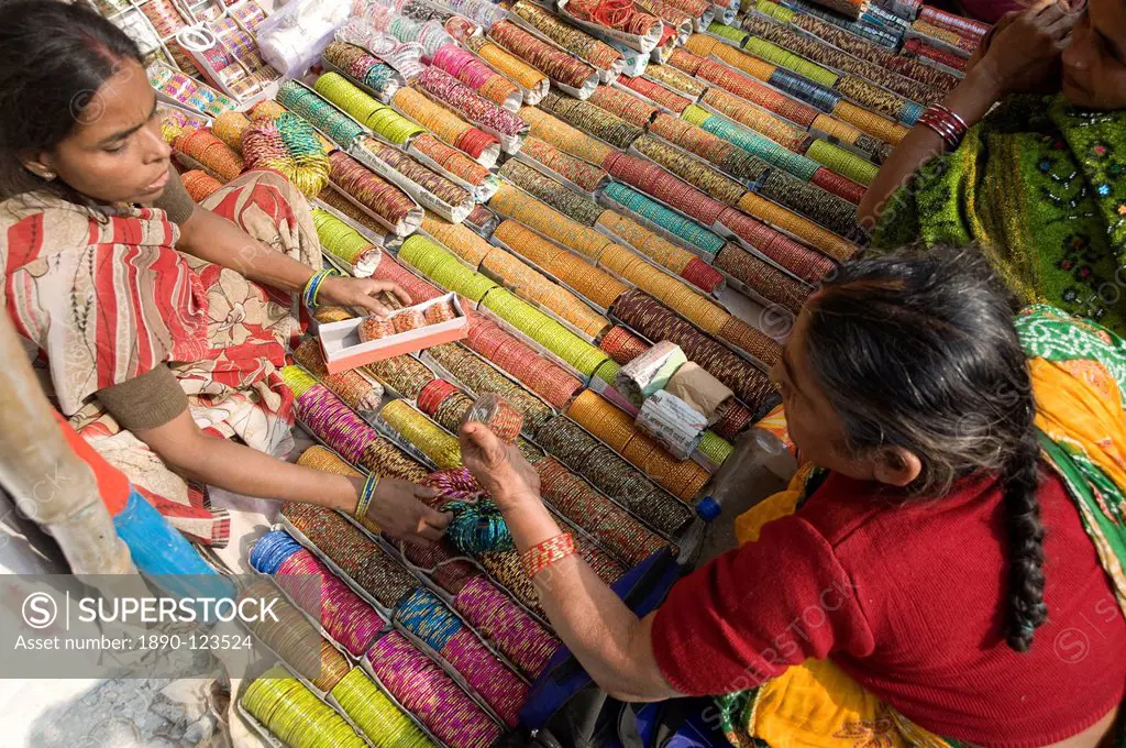 Woman buying bangles churidar from stall at Sonepur Cattle Fair, near Patna, Bihar, India, Asia