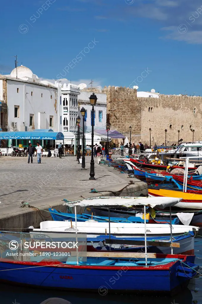 Fishing boats, old port canal with kasbah wall in background, Bizerte, Tunisia, North Africa, Africa