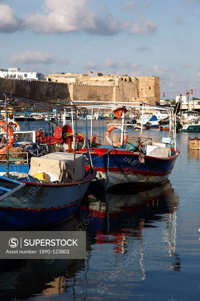Fishing boats, old port canal with kasbah wall in background, Bizerte, Tunisia, North Africa, Africa