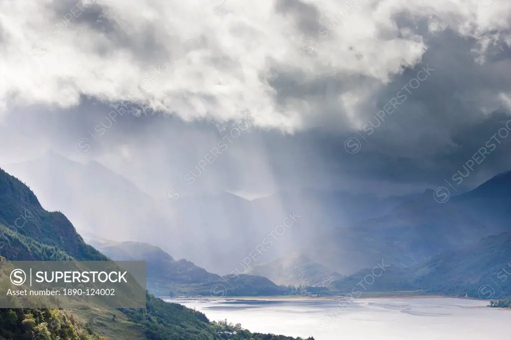 View from Carr Brae towards head of Loch Duich and Five Sisters of Kintail with rays of sunlight bursting through sky, Highlands, Scotland, United Kin...