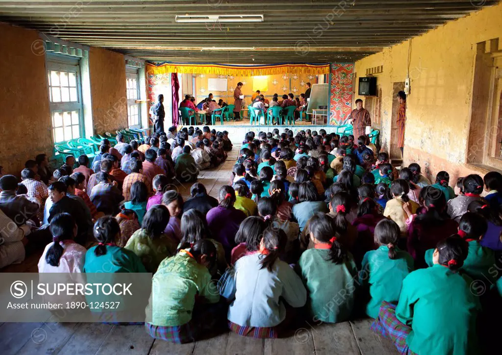 Pupils and teachers in the main hall of their school taking part in a spelling competition, Ura Village, Ura Valley, Bumthang, Bhutan, Asia