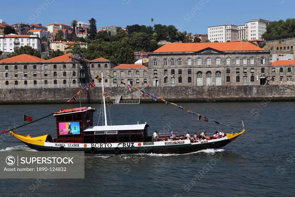 A wooden barcos rabelos boat, once used of delivering wine casks, cruises on the River Douro at Porto, Douro, Portugal, Europe