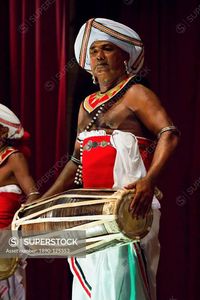 Drummer in a Pancha Thuryas Kandyan dance orchestra at tourist show in the Kandyan Arts Association Hall, Kandy, Sri Lanka, Asia
