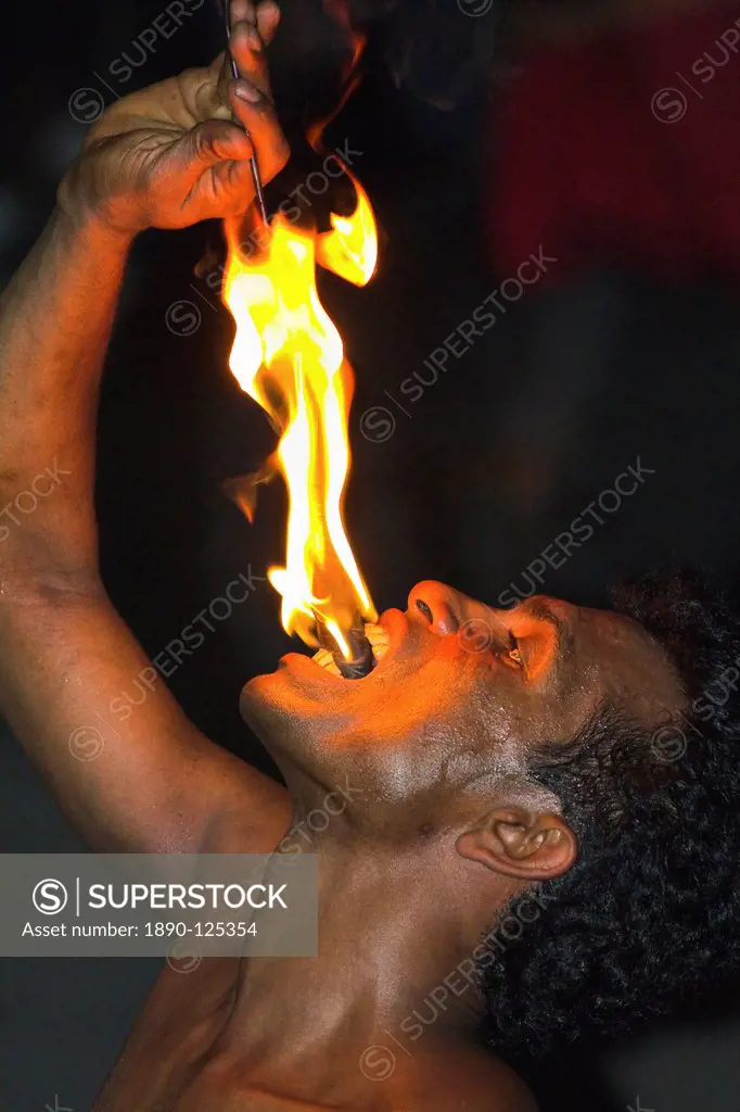 Man eating fire during the Fire Walking at a Kandyan dance show in the Kandyan Arts Association Hall, Kandy, Sri Lanka, Asia