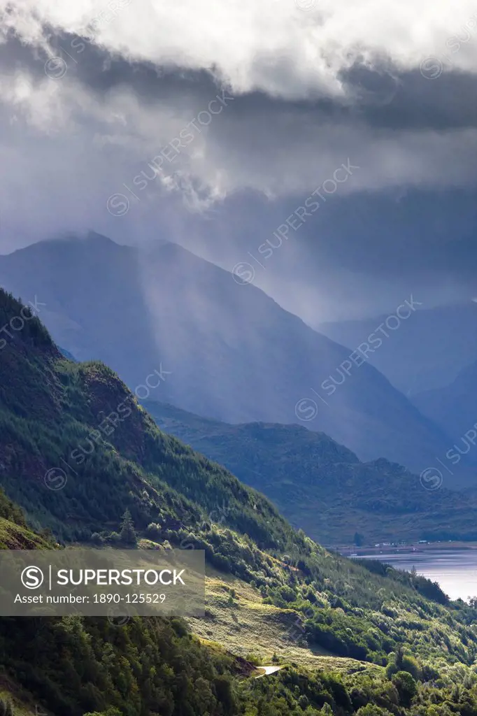 View from Carr Brae towards head of Loch Duich and Five Sisters of Kintail with sunlight bursting through sky, Highlands, Scotland, United Kingdom, Eu...