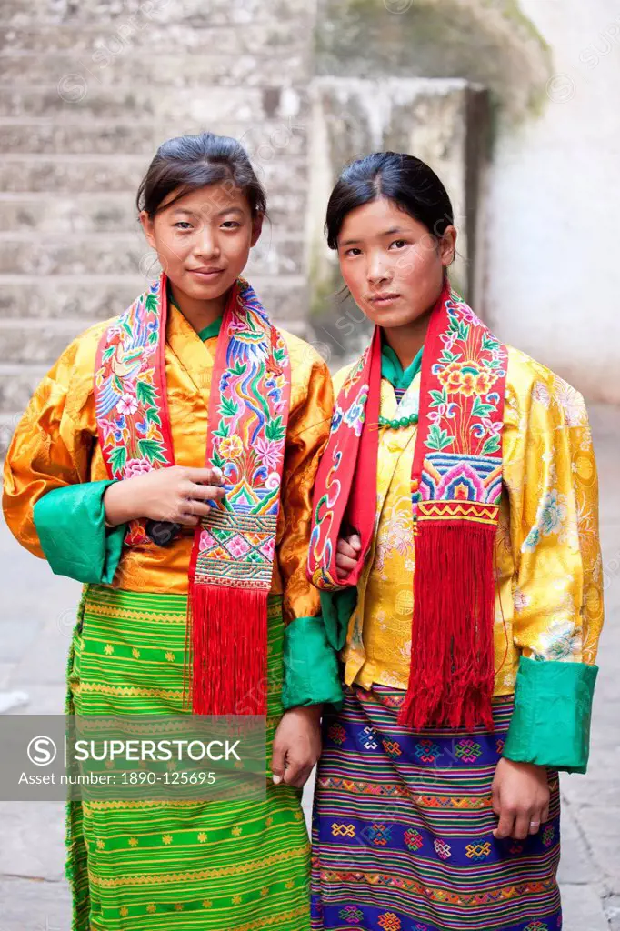 Two young woman in colourful national dress at the Wangdue Phodrang Tsechu, Wangdue Phodrang Dzong, Wangdue Phodrang Wangdi, Bhutan, Asia