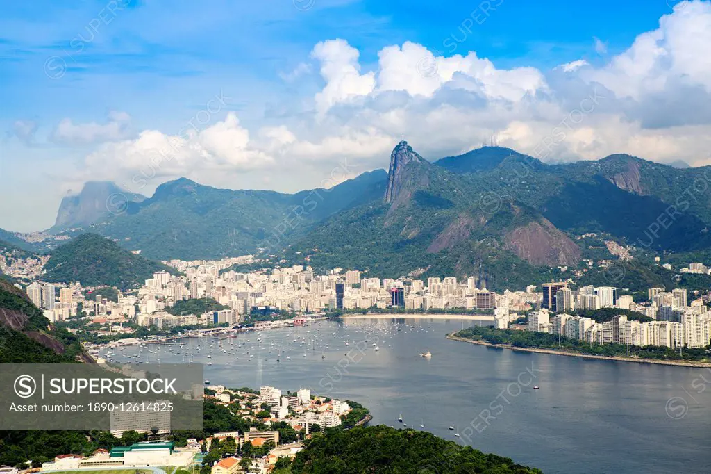 Aerial view of the city and Serra da Carioca mountains with Botafogo Bay, Corcovadao and the Christ in the foreground, Rio de Janeiro, Brazil, South A...