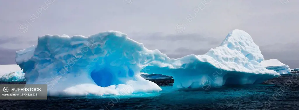 Weathered iceberg in the Iceberg Graveyard off Pleneau Island, Antarctic Peninsula, Antarctica, Polar Regions