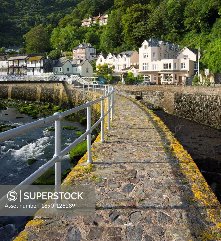 Stone harbour wall and village of Lynmouth on a summer morning, Exmoor National Park, Devon, England, United Kingdom, Europe