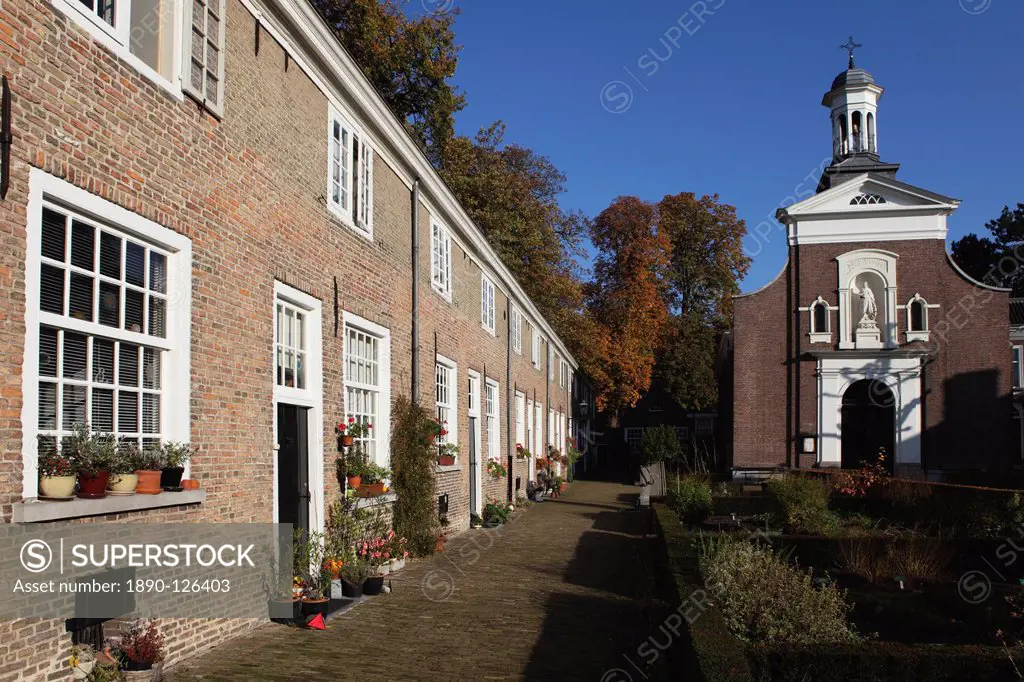 Chapel and brick housing within the courtyard of the Begijnhof Beguinage in Breda, Noord_Brabant, Netherlands, Europe