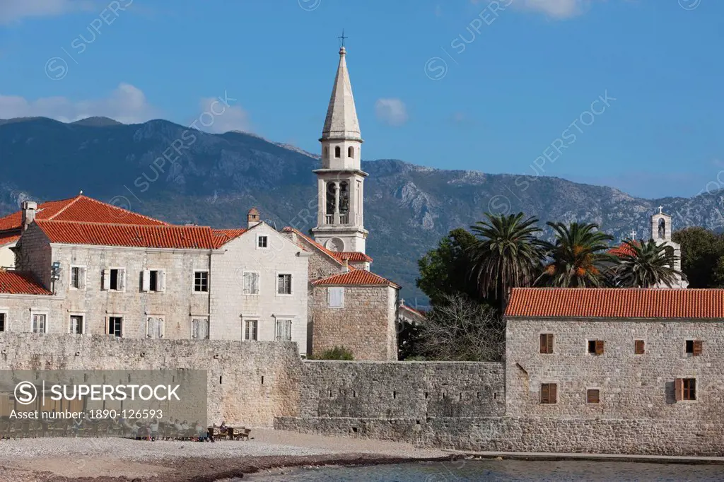 Budva fortified old town on the Adriatic coast with the tower of St. John´s Church and Budva beach, Budva, Montenegro, Europe