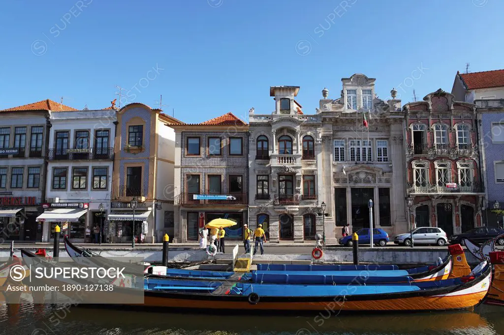 Moliceiro boats docked by Art Nouveau style buildings along the Central Canal, Aveiro, Beira Litoral, Portugal, Europe