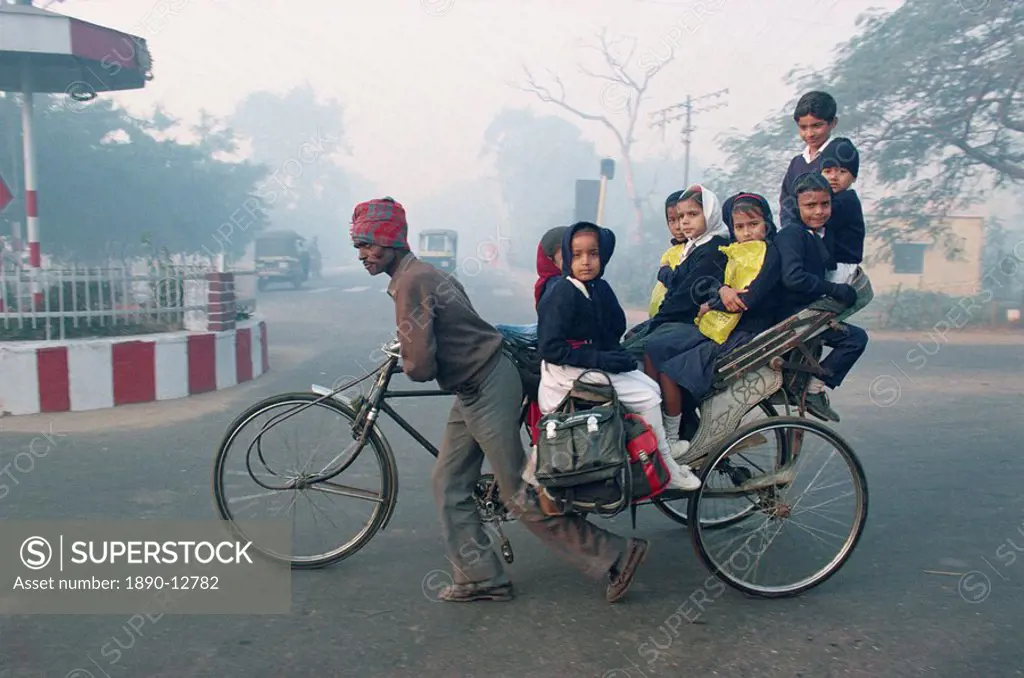 School children riding in a rickshaw in Agra, Uttar Pradesh state, India, Asia