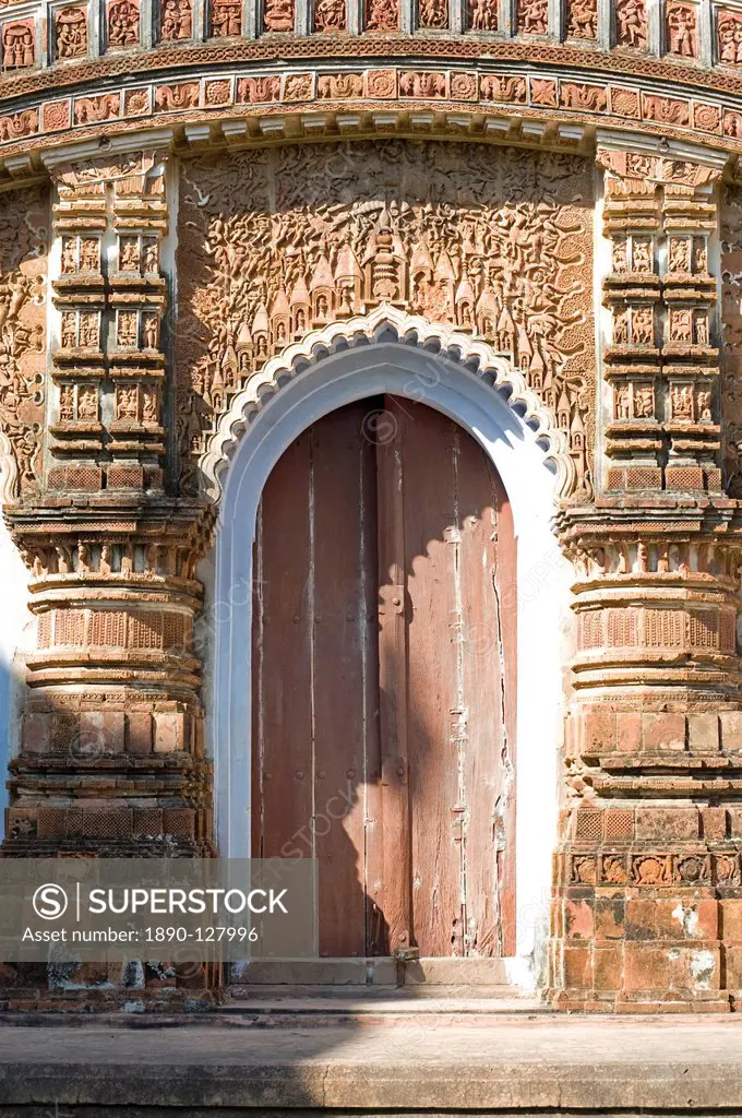 Ornate carving of Hindu myths above a door in the restored miniature terracotta Hindu temple in Baranagar, rural West Bengal, India, Asia