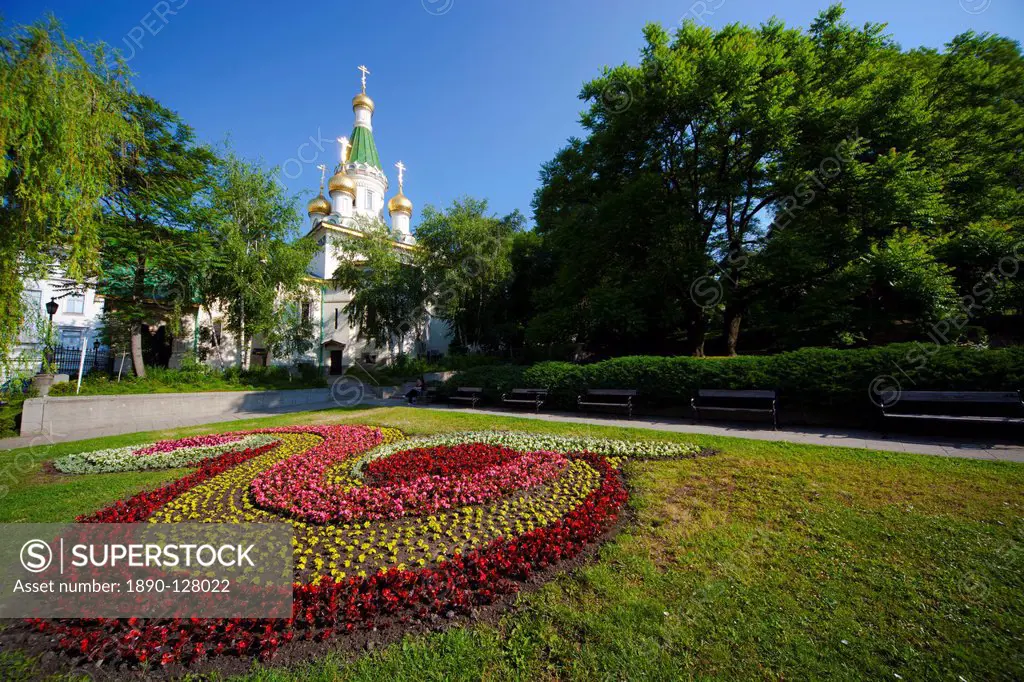 Flower bed in gardens with Church of St. Nicholas the Miracle Maker The Russian Church, behind, Boulevard Tsar Osvoboditel, Sofia, Bulgaria, Europe
