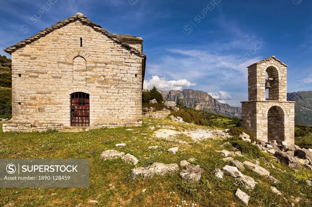 Ancient church on the edge of the semi abandoned village of Ano Klidonia in Zagoria, with the Astraka peaks in the distance, Epirus, Greece, Europe