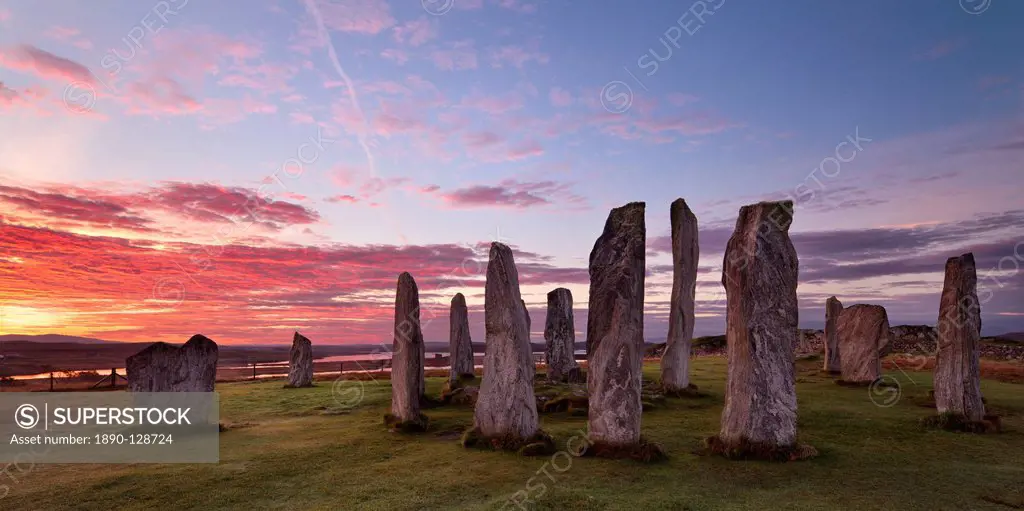 Fiery clouds above the standing stones of Callanish at sunrise in autumn, Island of Lewis, Outer Hebrides, Scotland, United Kingdom, Europe