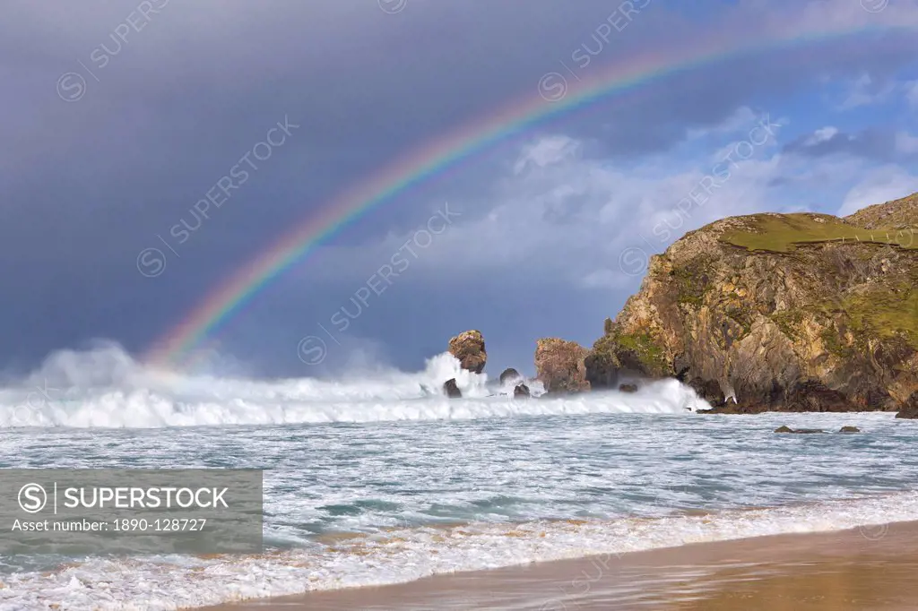 Sea stacks, rainbow, stormy clouds and rough seas on a windy afternoon at Dalmore Bay on the Isle of Lewis, Outer Hebrides, Scotland, United Kingdom, ...