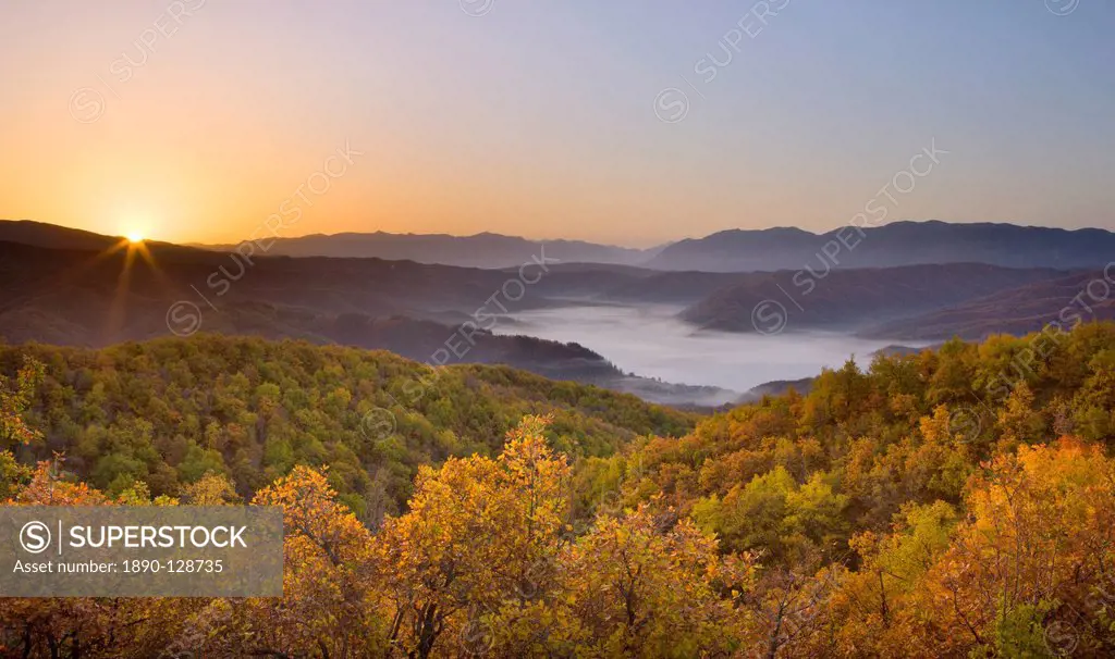 Autumn sunrise in Zagoria with the village of Kipi and a mist filled valley below, Epirus, Greece, Europe