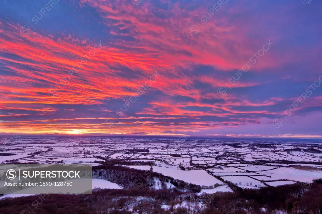 Fiery sunset over a snow covered Gormire Lake from Sutton Bank on the edge of the North Yorkshire Moors, Yorkshire, England, United Kingdom, Europe