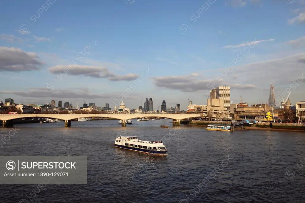 A cruise boat on River Thames, ahead of Waterloo Bridge and the skyline of the City, from Westminster, London, England, United Kingdom, Europe