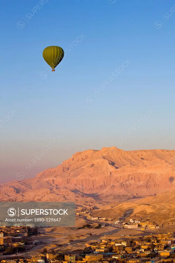 Hot air balloon suspended over the Theban hills of Luxor, Egypt, North Africa, Africa