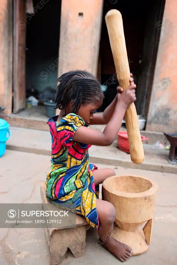 Girl pounding food, Lome, Togo, West Africa, Africa