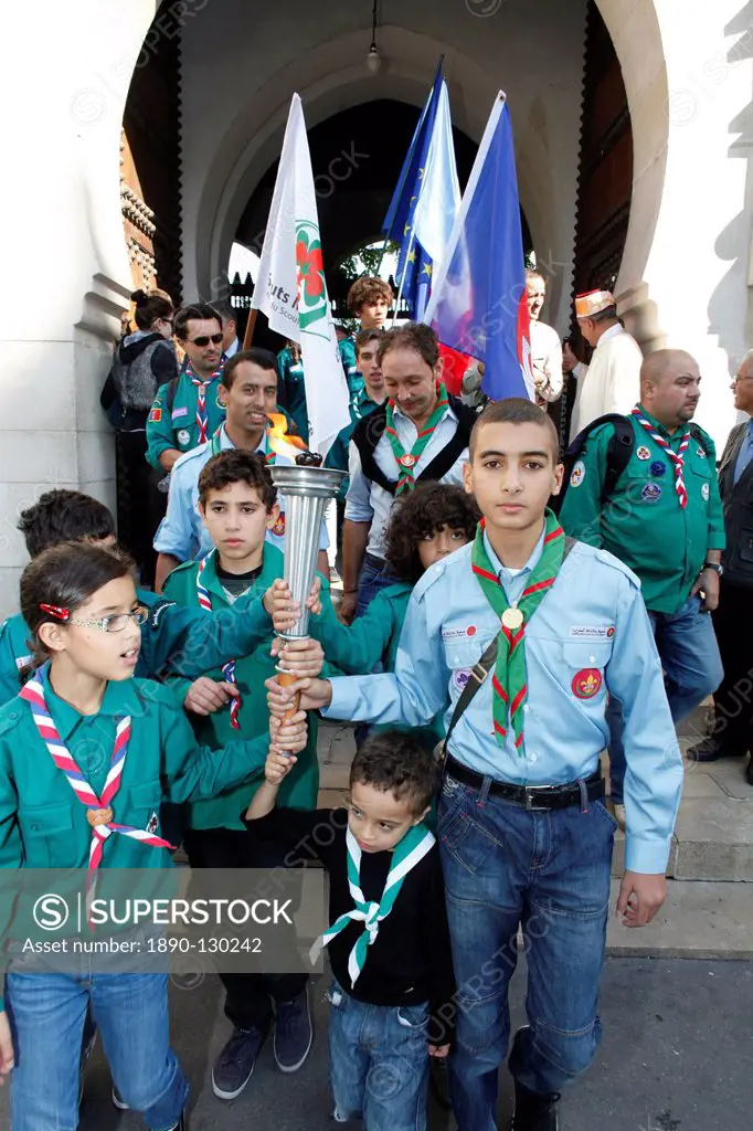 Muslim scouts coming out of the Paris Great Mosque carrying a torch, Paris, France, Europe