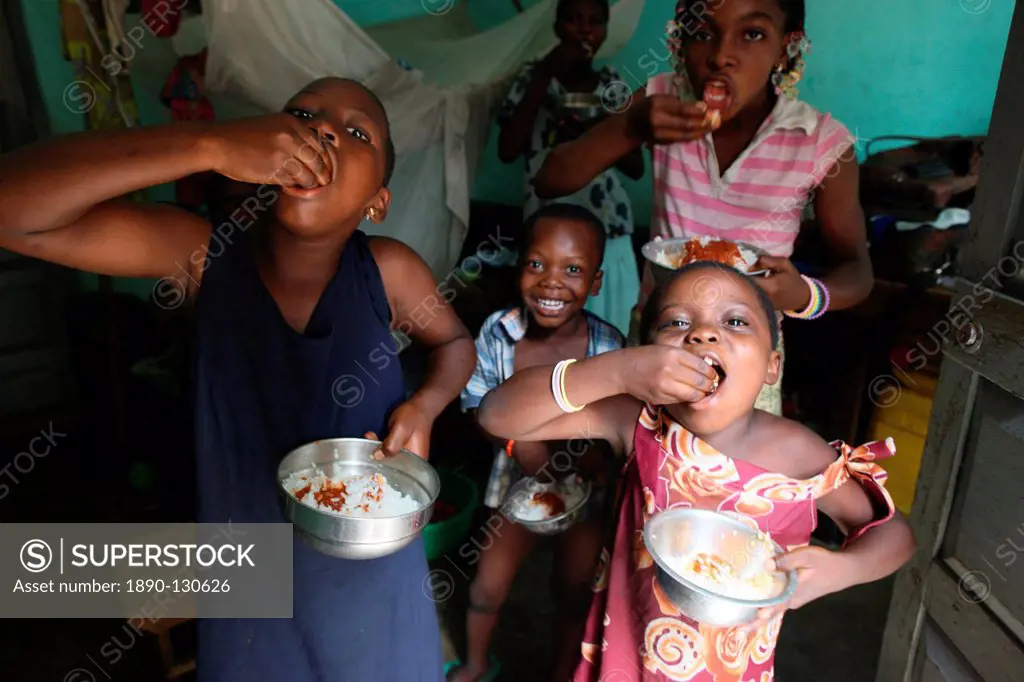 Children eating a meal, Lome, Togo, West Africa, Africa