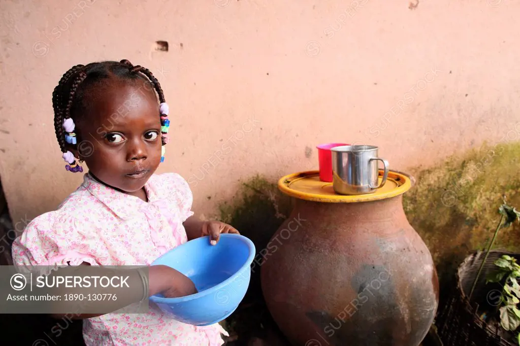 Girl eating a meal, Lome, Togo, West Africa, Africa